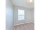 Bedroom featuring a window with blinds and carpet at 6410 Avacado Dr, Indianapolis, IN 46217