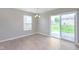 Bright dining area featuring sliding glass doors, window, and tile floor at 6410 Avacado Dr, Indianapolis, IN 46217