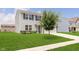 Attractive home with a well-kept lawn, tree, blue shutters, and two car garage at 6410 Avacado Dr, Indianapolis, IN 46217