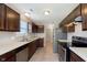 Well-equipped kitchen featuring stainless steel appliances and dark wood cabinets at 6410 Avacado Dr, Indianapolis, IN 46217