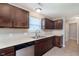 Functional kitchen with stainless steel dishwasher, sink, and dark cabinets at 6410 Avacado Dr, Indianapolis, IN 46217