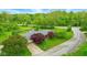 Aerial view of a home with mature trees, a well-kept yard, and a driveway at 6462 Wings Ct, Brownsburg, IN 46112