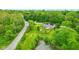 Aerial view of a home with a pond, fenced yard, playset, shed, and mature trees at 6462 Wings Ct, Brownsburg, IN 46112