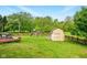 A large backyard offers a shed, privacy fence and playset at 6462 Wings Ct, Brownsburg, IN 46112