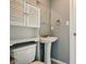 This bathroom features a pedestal sink, white cabinets, and a well-lit mirror at 6462 Wings Ct, Brownsburg, IN 46112
