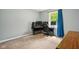 Bedroom with a computer setup, featuring natural light and neutral carpet at 6462 Wings Ct, Brownsburg, IN 46112