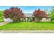 Charming brick home with well-manicured lawn, mature trees, and an attached two-car garage at 6462 Wings Ct, Brownsburg, IN 46112