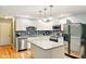 Well-lit kitchen with white cabinets, stainless steel appliances, and granite countertops at 6462 Wings Ct, Brownsburg, IN 46112