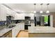 Bright kitchen featuring white cabinetry, stainless steel appliances, and a granite countertop island at 6462 Wings Ct, Brownsburg, IN 46112