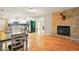 Open-concept living space with fireplace, leading into kitchen with stainless appliances at 6462 Wings Ct, Brownsburg, IN 46112