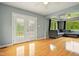 Spacious living area featuring hardwood floors, large windows, and double glass doors at 6462 Wings Ct, Brownsburg, IN 46112