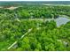 An aerial shot featuring a beautiful neighborhood with a large lake and lush greenery at 6794 E Ann St, Camby, IN 46113