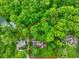 Aerial view of a home with a defined property line nestled among lush greenery and mature trees at 6794 E Ann St, Camby, IN 46113