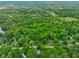 A tranquil aerial view showcases a lush, wooded landscape, speckled with residences at 6794 E Ann St, Camby, IN 46113