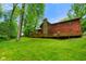 Scenic view of home's backyard, showcasing a sprawling lawn, mature trees, and a large wooden deck at 6794 E Ann St, Camby, IN 46113