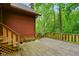 View of back deck featuring wooden railings, stairs, potted plants, and mature trees at 6794 E Ann St, Camby, IN 46113