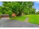 Scenic view of the property featuring a long driveway, lush greenery, and a well-maintained garage at 6794 E Ann St, Camby, IN 46113