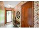 Charming foyer with unique wallpaper, decorative mirror, and a view of the front door at 6794 E Ann St, Camby, IN 46113