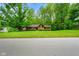 Charming one-story home featuring a well-manicured lawn, mature trees, and a welcoming entrance at 6794 E Ann St, Camby, IN 46113