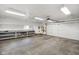 Spacious garage with built-in shelving, workspace, and garage door leading to the home's exterior at 6794 E Ann St, Camby, IN 46113