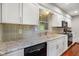 Well-lit kitchen with white cabinets, tiled backsplash, and updated appliances at 6794 E Ann St, Camby, IN 46113