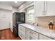 Kitchen featuring white cabinets, dark appliances, and a connecting dining area at 6794 E Ann St, Camby, IN 46113