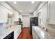 Bright kitchen with white cabinets, modern appliances, and light countertops at 6794 E Ann St, Camby, IN 46113
