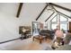 Bright living room features exposed beams, large windows, and an open-concept layout at 6794 E Ann St, Camby, IN 46113