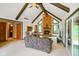 Inviting living room featuring a stone fireplace, exposed wood beams, and a vaulted ceiling at 6794 E Ann St, Camby, IN 46113