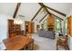 Open-concept living room and dining area featuring exposed beams and a stone fireplace at 6794 E Ann St, Camby, IN 46113