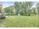 Large backyard area with mature trees and a storage shed providing lots of space at 7503 Grandview Dr, Indianapolis, IN 46260