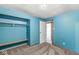 Bedroom with a closet and blue walls with carpet floors at 7503 Grandview Dr, Indianapolis, IN 46260