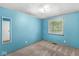 Bedroom with a window, a mirror and blue walls with carpet floors at 7503 Grandview Dr, Indianapolis, IN 46260