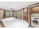 Kitchen area showcasing wood cabinets, an island, a dining table and a washing machine and dryer at 7503 Grandview Dr, Indianapolis, IN 46260
