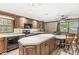 The kitchen features an island, stainless steel appliances, wood cabinets, and a dining area at 7503 Grandview Dr, Indianapolis, IN 46260