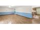 Spacious living room with wood-look flooring and access to kitchen at 7503 Grandview Dr, Indianapolis, IN 46260
