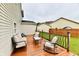 Relaxing backyard wooden deck with comfortable seating and views of the surrounding yard at 7604 Cloudy Ct, Camby, IN 46113