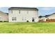 Well-manicured lawn with a deck, and rear exterior view of the two-story home with neutral siding at 7604 Cloudy Ct, Camby, IN 46113