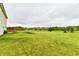 Vast backyard with lush green lawn, picnic table, and trampoline offering space for activities at 7604 Cloudy Ct, Camby, IN 46113