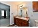 Bathroom featuring a double sink vanity, toilet, and a doorway to a bedroom at 7604 Cloudy Ct, Camby, IN 46113