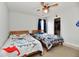 Bright bedroom with two twin beds, fan and window at 7604 Cloudy Ct, Camby, IN 46113