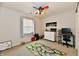 Bright bedroom features a colorful ceiling fan, neutral walls, and a play area with a vibrant road map rug at 7604 Cloudy Ct, Camby, IN 46113