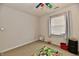 Bright bedroom features a colorful ceiling fan, neutral walls, and a play area with a vibrant road map rug at 7604 Cloudy Ct, Camby, IN 46113