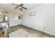 Bright bedroom boasts wood-look floors, natural light, and classic wainscoting for added charm at 7604 Cloudy Ct, Camby, IN 46113