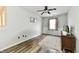 Bright bedroom boasts wood-look floors, natural light, and classic wainscoting for added charm at 7604 Cloudy Ct, Camby, IN 46113