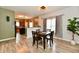Bright dining space featuring wood table, laminate floors, and open kitchen view at 7604 Cloudy Ct, Camby, IN 46113