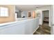 View of a neutrally decorated hallway leading to bedrooms, with a small seating area in the background at 7604 Cloudy Ct, Camby, IN 46113