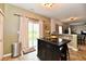 An eat-in kitchen featuring a kitchen island with barstool seating, sliding glass doors, and tiled floors at 7604 Cloudy Ct, Camby, IN 46113