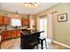 Cozy kitchen featuring dark wood cabinets, granite countertops, a center island, and stainless steel appliances at 7604 Cloudy Ct, Camby, IN 46113