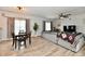 Cozy living room with natural light, wood laminate floors, and stylish furnishings at 7604 Cloudy Ct, Camby, IN 46113